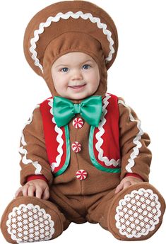 a baby dressed in a gingerbread costume