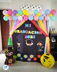 a decorated graduation backdrop with balloons and decorations