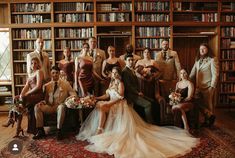 a group of people posing for a photo in front of bookshelves