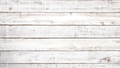 an old white painted wood planks textured with peeling paint and chipped edges