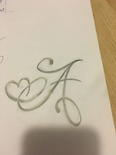 the letter a is drawn in pencil on paper