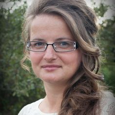 a close up of a person wearing glasses