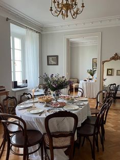 a dining room table is set with plates and glasses