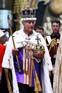 an older man wearing a crown and holding a golden object