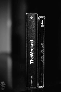 a black and white photo of two books sitting on a table with the title between them