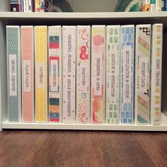 a book shelf filled with lots of books on top of a wooden floor