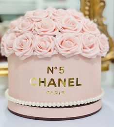 a close up of a cake with flowers on it and pearls around the edges that says no 5 chanel paris