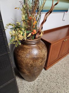 a large vase with some flowers in it