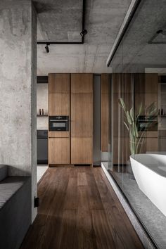 a modern kitchen and living room with wood flooring in an industrial style home on the outskirts of town