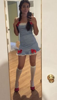 a woman taking a selfie in front of a mirror with her cell phone and socks on