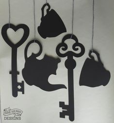 the silhouettes of cats and keys are hanging from chains