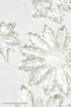 several clear crystal snowflakes on a white surface