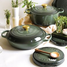 green pots and pans are sitting on the table