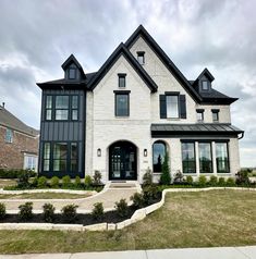 a large white house with black trim and windows