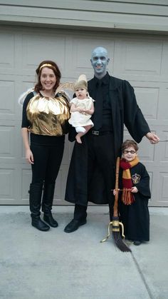 two adults and a child dressed up as harry potter and hermione