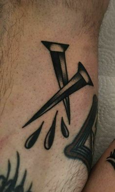 a close up of a person's foot with tattoos on it and an arrow in the middle