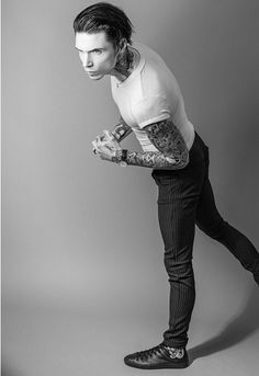 a man with tattoos on his arm and leg