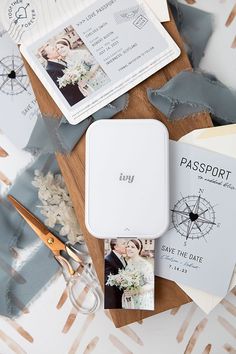 passport, wedding photos and scissors on a table