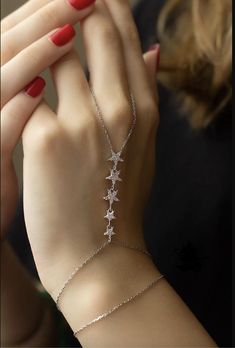 Shahmaran Star Hand Chain Bracelet 925 Sterling Silver with Zircon Stones, White Silver Chain Bracelet Assyrian Kurdish Bracelet Large Star Diameter 7 mm, Small Star Diameter 5 mm Sequential Star Length 4 cm Additional Extension Chain 5 cm Shahmaran is a mythical figure deeply rooted in Persian, Kurdish folklore. The name "Shahmaran" comes from the Persian words "Shah" meaning king and "Maran" meaning snakes, translating to "Queen of the Snakes." She is depicted as a beautiful, wise woman with t Hand Chain Bracelet Silver, Kurdish Folklore, Hand Chain Bracelet, Wise Women, Silver Chain Bracelet, Hand Chain, Chain Link Bracelet, White Silver, Chain Bracelet