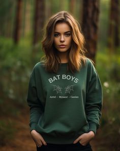 Introducing the exclusive Bat Boys ACOTAR Sweatshirt, a must-have for fans of the popular A Court of Thorns and Roses series! This stylish and unique sweatshirt celebrates the beloved characters of the Night Court: Rhysand, Azriel, and Cassian, aka the Bat Boys. With its intricate design and comfortable fit, this sweatshirt is perfect for showcasing your love for these iconic characters. Join the Night Court revolution and wear your love for the Bat Boys ACOTAR proudly Green Band Merch Top For Fall, Pop Culture Fan Merchandise Sweatshirt For Fall, Fall Pop Culture Fan Merchandise Sweatshirt, Alternative Style Letter Print Sweatshirt For Fall, Fan Merchandise Fall Sweatshirt With Screen Print, Alternative Crew Neck Sweatshirt With Letter Print, Pre-shrunk Band Merch Sweatshirt For Fall, Alternative Letter Print Crew Neck Sweatshirt, Alternative Style Letter Print Crew Neck Sweatshirt