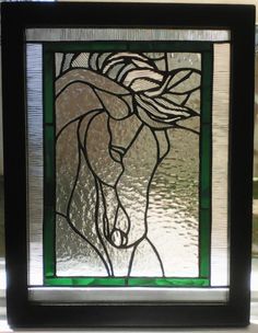 a stained glass window with a horse on it