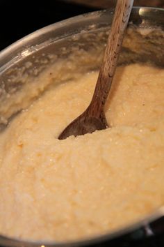 a wooden spoon stirring batter in a pot