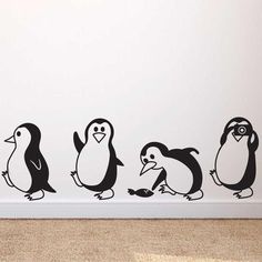 the penguins are lined up against the wall in this children's room, which is decorated with black and white decals