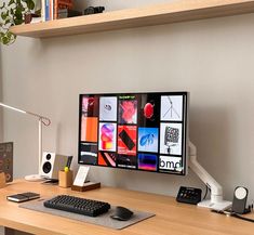 a computer monitor sitting on top of a wooden desk