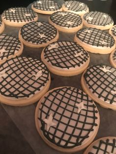 cookies decorated with black and white icing on a table