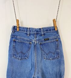 "Vintage womens Wrangler jeans featuring; ~ traditional 5 pocket styling   zip fly with single button at the waist   high waisted   small black \"Wrangler\" tab on back   triple stitched outer seam   straight leg   slim fit ~ of a heavyweight, 100% cotton denim in a faded, medium blue wash ~ tagged a size 11 junior,  34 X 32, measurements when laid out flat are; 13 inches at the waist 18 inches at the hip 12 1/4 inch rise 31 1/2 inch inseam ~ in good, preworn, vintage condition with no holes, st Vintage Wrangler Jeans, Cowgirl Jeans, Vintage Wrangler, Jean Vintage, Wrangler Jeans, Cow Girl, Medium Blue, High Jeans, High Waist Jeans