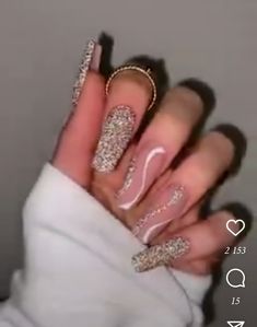 a woman's hand with long, shiny nails and gold glitters on it