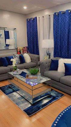 a living room filled with furniture and blue curtains