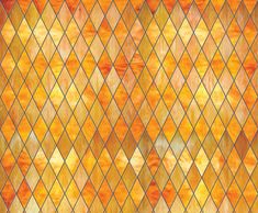 an orange and yellow stained glass window with diamond shapes on it's sides, as well as the background