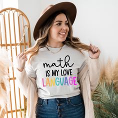 Math Teacher shirt, Math is my Love LanguageOur new Math is My Love Language, Gift for Math teacher tshirt-bright is now available in gray and white with rainbow wording. It's the perfect shirt for math teachers, teachers who love math, or even an accountant. This inspirational teacher shirt is a reminder that math is indeed a love language. This tshirt is the perfect addition to our Signature Nevertheless She Taught Collection, Teach With Love, or Teach with Flair collection.This math tee is th Math Teacher Shirts Designs, Math Tshirt, Teach Love Inspire Shirt, Teacher Things Shirt Math, Math Teacher Tshirt, Teacher Aesthetic, Math Teacher Shirts, Teacher Mom, Love Math