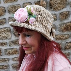 a woman with red hair wearing a hat