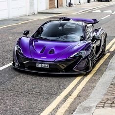 the purple sports car is parked on the side of the road