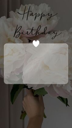 a person holding a bouquet of flowers with the words happy birthday written on it's side