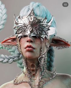 an image of a woman with blue hair and horns on her head, wearing silver jewelry