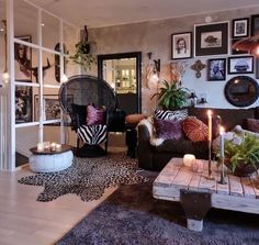 a living room filled with furniture and candles