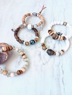 Earthy, natural, cozy, and everyday. Beautiful beige, white, cream, brown, and touches of sienna and rust in these mixed medium stack bracelets. Several gemstone varieties in different sizes, finishes, and colors. Several Jaspers, Tibetan Agate, Fossilized Coral, Picture Jasper rondelle, and many ethical bone beads in a variety of colors and shapes. Mix these in with recycled glass, Ebonywood, beads, Kente Krobe sand glass beads, shell, coconut disks, and mixed metals. Unique and stunning. Strung on heavy duty elastic. The item/s pictured is the item you will receive. Bracelets is 7.0" to 7.5" in length. HavSolStudio on ETSY | Mixed media . Earthy elegance . Great texture . Beach inspired . Coastal calm . A little rustic . Worldly . Alluring . Recycled glass . Reuse . Repurpose . Statement Twine And Twig, Sand Glass, Stack Bracelets, Fossilized Coral, Hippie Bracelets, Bone Beads, Picture Jasper, Beach Inspired, Lovely Jewellery