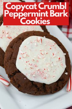 two chocolate peppermint bark cookies on a white plate with red and white candy canes