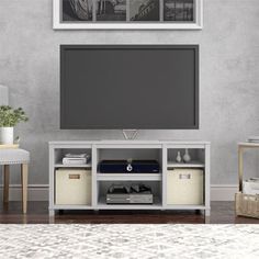 an entertainment center with a large flat screen tv on top of it's stand