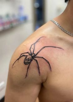 a man with a spider tattoo on his shoulder