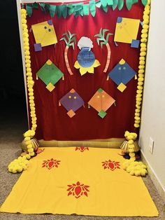 a room decorated in yellow and red with decorations on the wall, along with pom poms