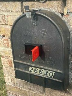 a black mailbox with a red box on it's front and the number two