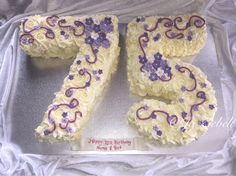 a birthday cake that has the number twenty five on it, decorated with purple and white icing