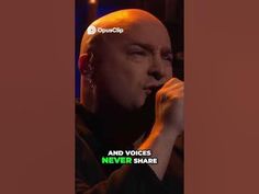 a bald man holding a microphone in his right hand with the words and voice never share on it