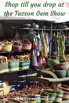 an outdoor market with baskets and umbrellas on the shelves, text reads shop till you drop at the tucson gen show