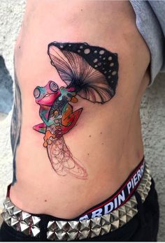 a woman's stomach with a butterfly tattoo on it