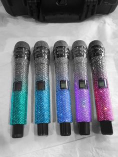 four different colored microphones sitting next to each other